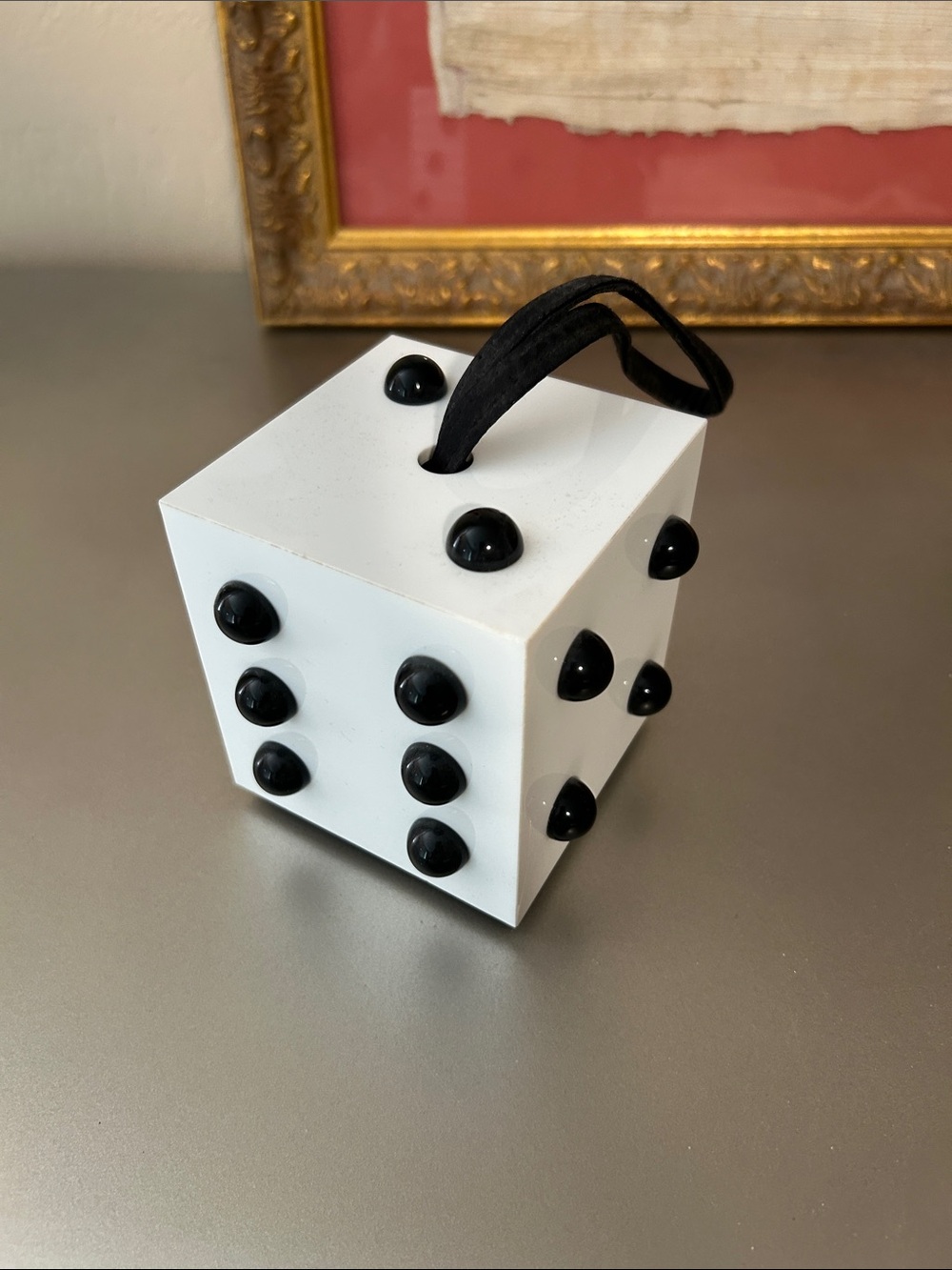 Lulu Guinness wristlet that looks like a dice cube.